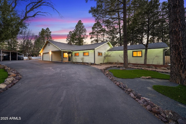 single story home featuring driveway and an attached garage