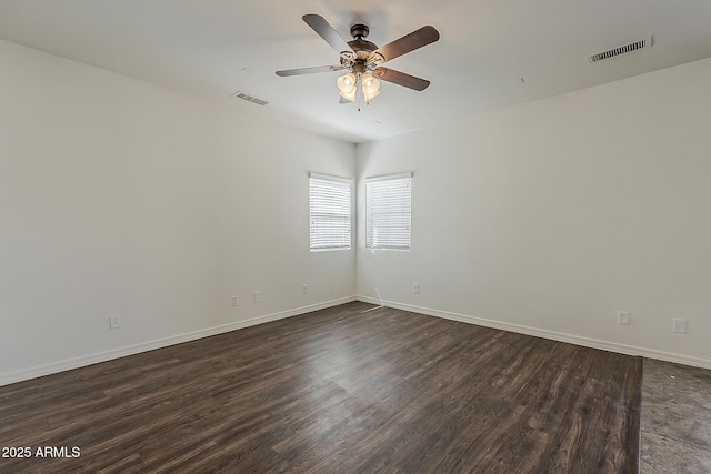 unfurnished room featuring visible vents, baseboards, a ceiling fan, and dark wood-style floors