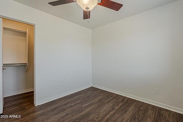 unfurnished bedroom with a ceiling fan, dark wood-style flooring, and baseboards