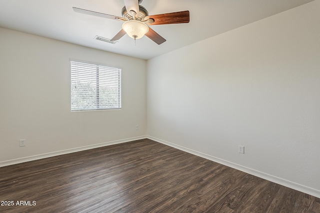 unfurnished room with baseboards, dark wood-style flooring, and visible vents