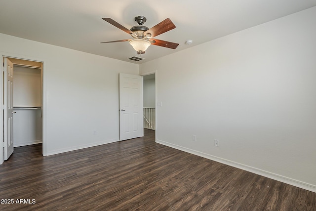 unfurnished bedroom with a ceiling fan, baseboards, dark wood-style floors, and visible vents