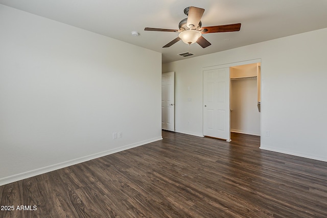 unfurnished bedroom with dark wood finished floors, visible vents, baseboards, and ceiling fan