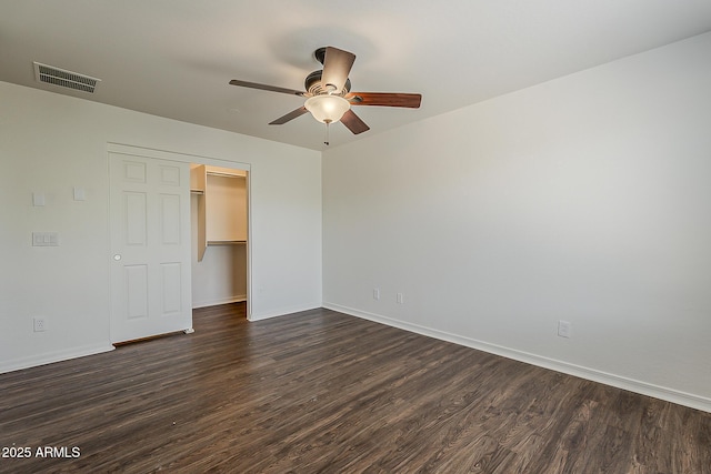 unfurnished bedroom with visible vents, baseboards, and dark wood-style floors