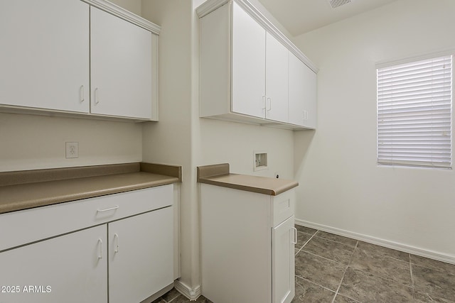 laundry room with baseboards, hookup for a washing machine, visible vents, and cabinet space