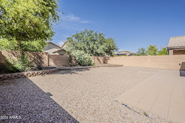 view of yard featuring a patio and a fenced backyard