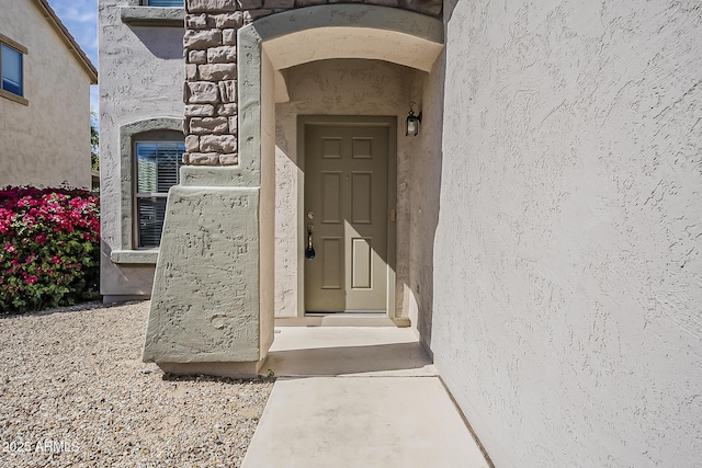 view of exterior entry with stucco siding