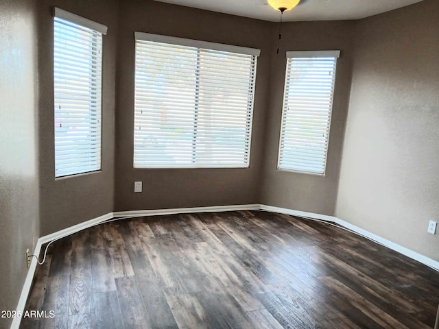 unfurnished room featuring dark hardwood / wood-style flooring