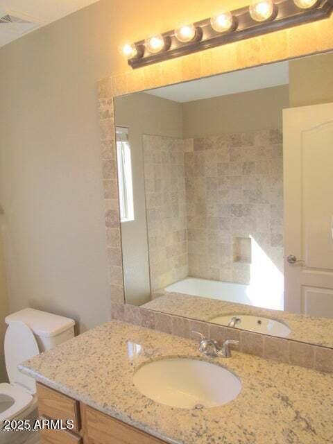 bathroom featuring vanity and toilet