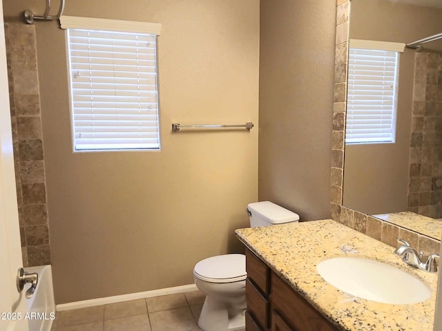 bathroom with tile patterned floors, vanity, toilet, and a shower