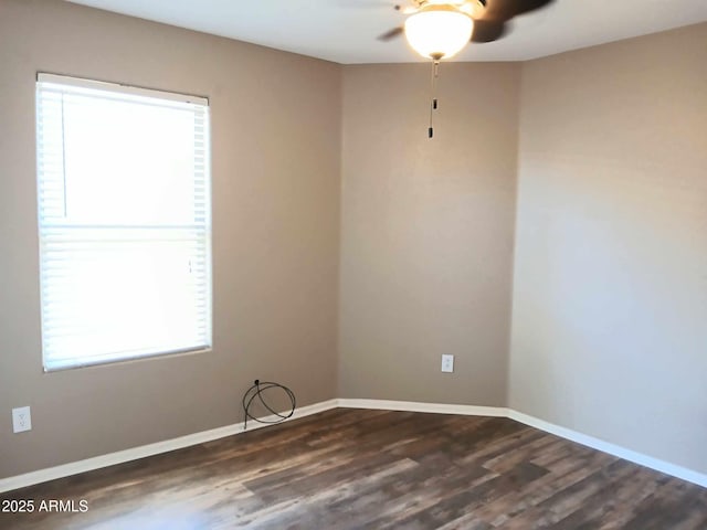 empty room with dark hardwood / wood-style floors, plenty of natural light, and ceiling fan