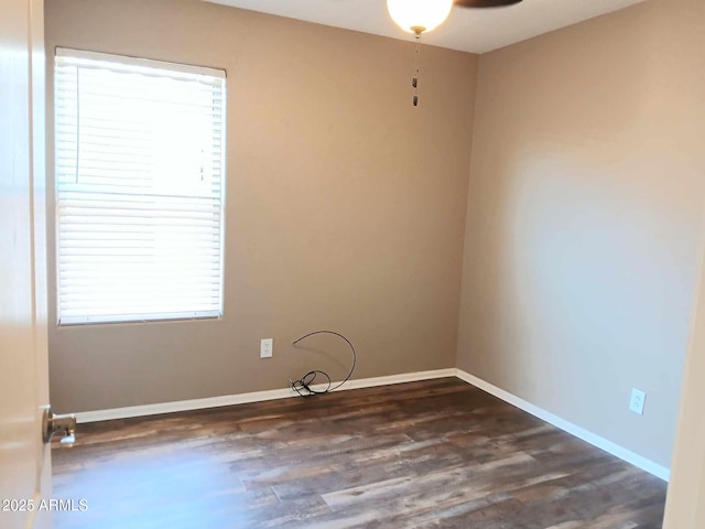 spare room featuring ceiling fan and dark wood-type flooring