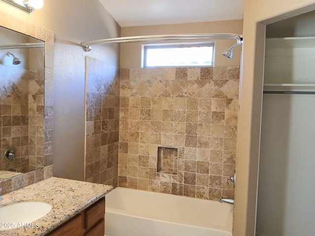 bathroom featuring vanity and tiled shower / bath combo