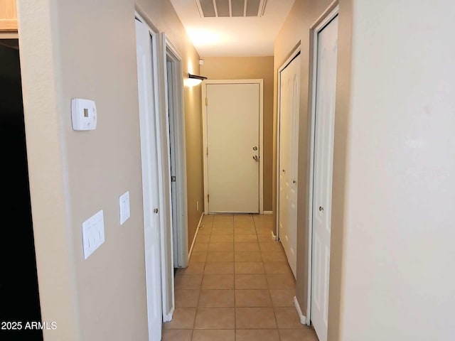 hallway featuring light tile patterned flooring