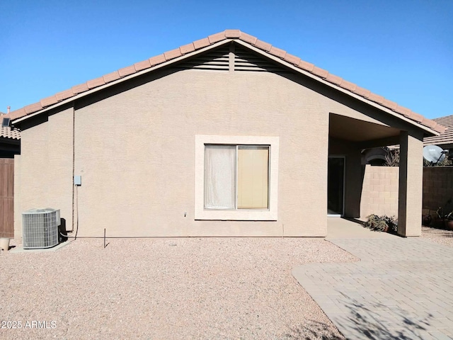 rear view of property featuring central AC and a patio