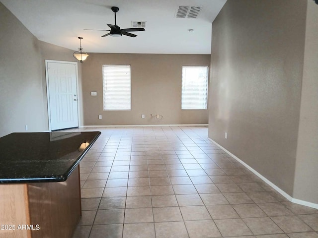 unfurnished living room featuring ceiling fan, light tile patterned flooring, and lofted ceiling