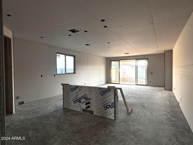 unfurnished room featuring concrete floors and plenty of natural light