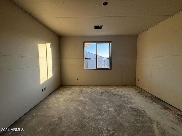 spare room with concrete floors