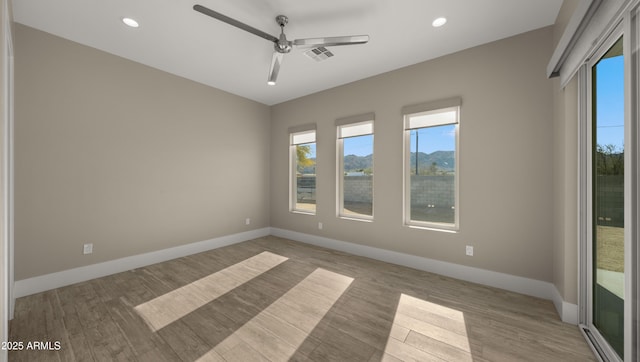 unfurnished room with ceiling fan and light hardwood / wood-style floors