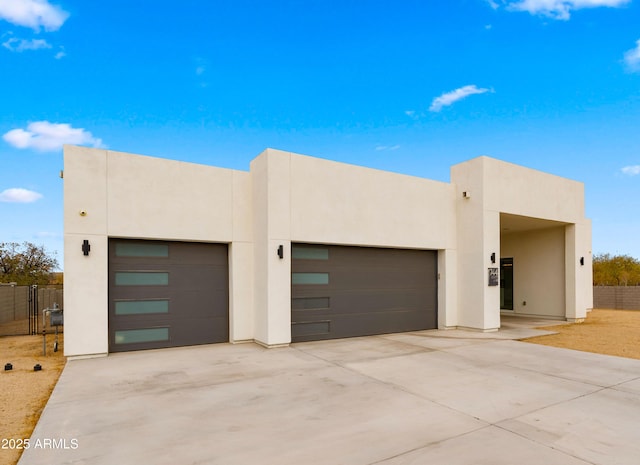 pueblo-style house featuring a garage