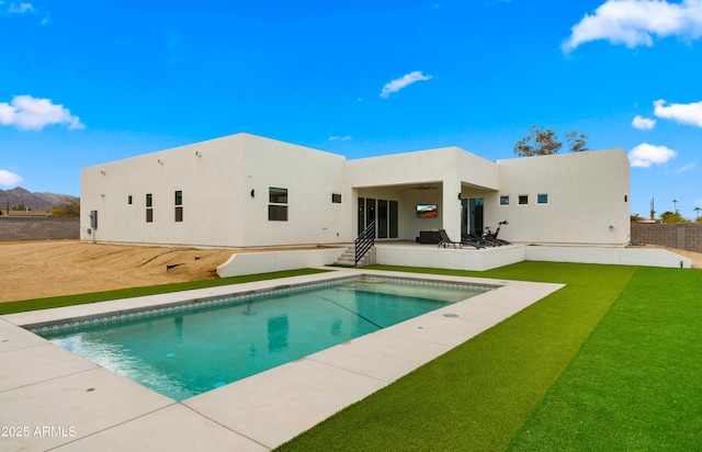 back of house with ceiling fan, a patio area, and a yard