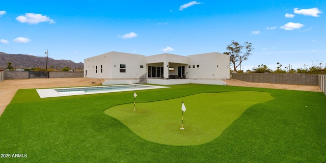 back of property featuring a mountain view, a fenced in pool, and a patio