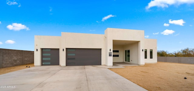 pueblo-style house with a garage