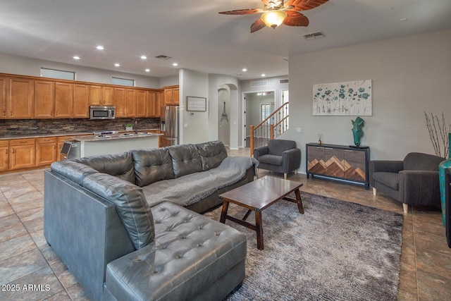 7252 E Nance St, Mesa, AZ 85207 - living room featuring arched walkways, a ceiling fan, recessed lighting, and stairway