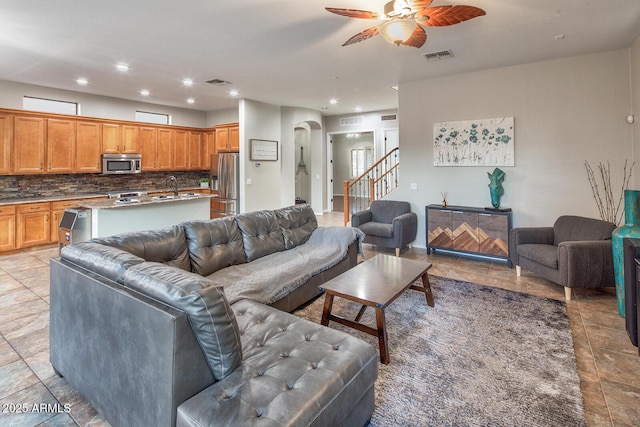 7252 E Nance St, Mesa, AZ 85207 - living room with arched walkways, ceiling fan, stairs, and recessed lighting