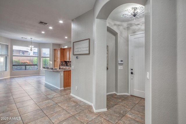 7252 E Nance St, Mesa, AZ 85207 - kitchen with a chandelier, recessed lighting, arched walkways, a textured wall, and pendant lighting