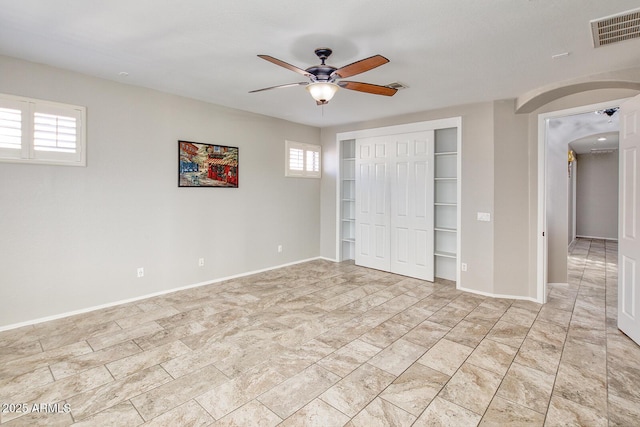 7252 E Nance St, Mesa, AZ 85207 - unfurnished bedroom featuring arched walkways, a closet, and ceiling fan