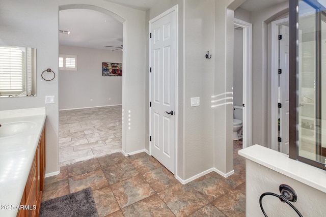 7252 E Nance St, Mesa, AZ 85207 - hallway with stone finish floors and arched walkways