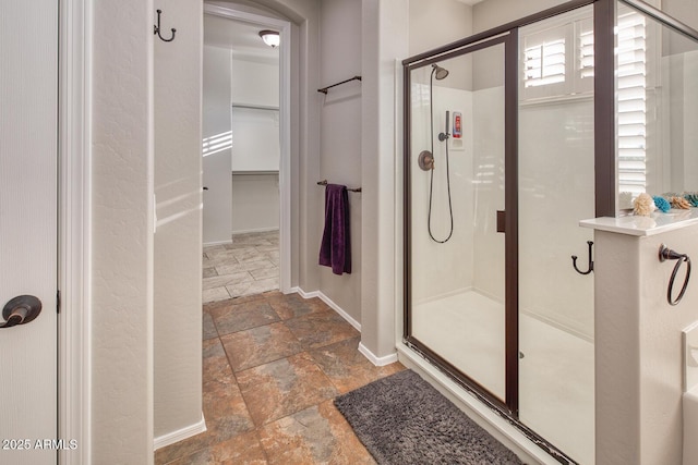 7252 E Nance St, Mesa, AZ 85207 - full bath with stone tile floors, a shower stall, and a walk in closet