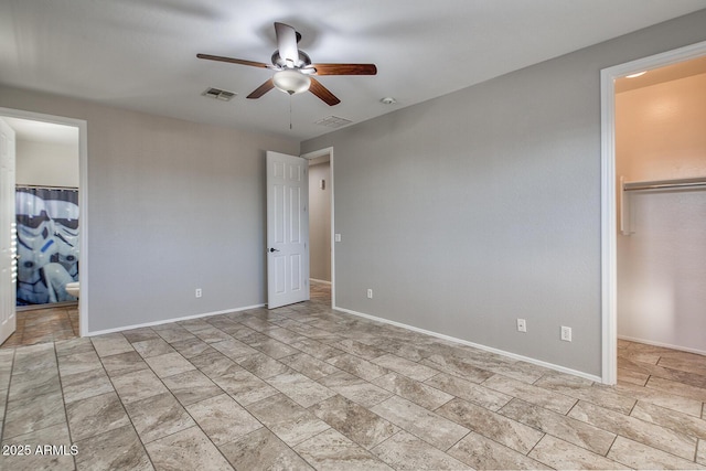 7252 E Nance St, Mesa, AZ 85207 - unfurnished bedroom featuring a walk in closet, a closet, connected bathroom, and ceiling fan
