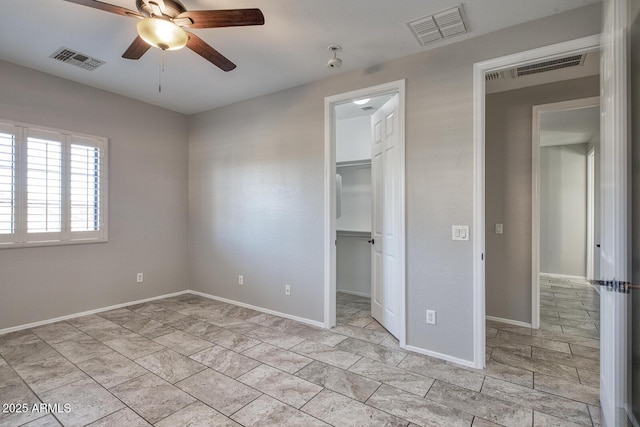7252 E Nance St, Mesa, AZ 85207 - unfurnished bedroom featuring a walk in closet, a closet, and ceiling fan