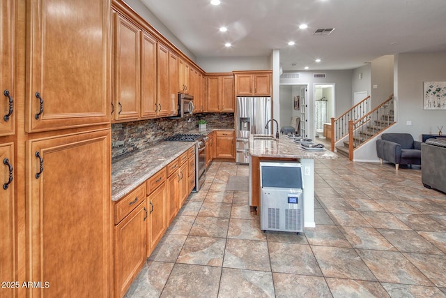 7252 E Nance St, Mesa, AZ 85207 - kitchen featuring stainless steel appliances, open floor plan, light stone countertops, tasteful backsplash, and an island with sink