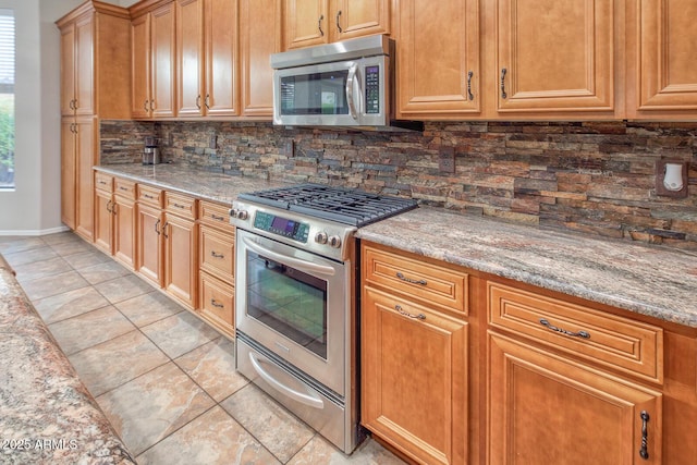 7252 E Nance St, Mesa, AZ 85207 - kitchen featuring stainless steel appliances, decorative backsplash, light tile patterned floors, and light stone counters