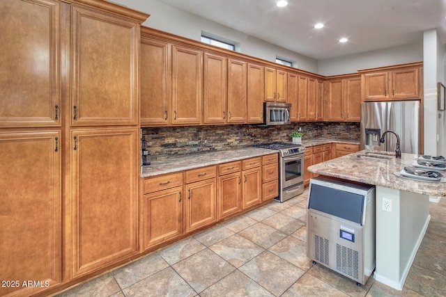 7252 E Nance St, Mesa, AZ 85207 - kitchen with stainless steel appliances, decorative backsplash, light stone counters, brown cabinetry, and recessed lighting