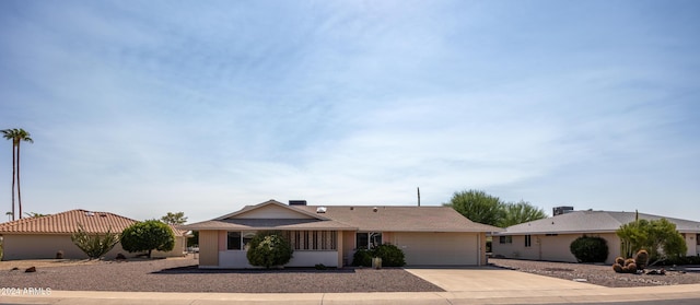 single story home with concrete driveway and a garage