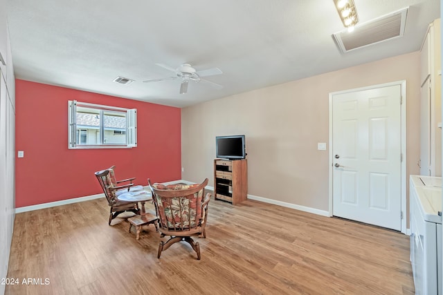 dining room featuring light wood finished floors, visible vents, and baseboards