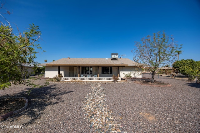 back of house featuring a porch, central AC unit, and fence