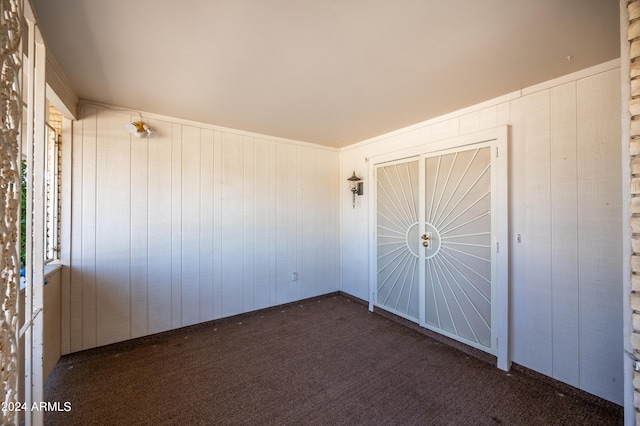 unfurnished bedroom with dark colored carpet