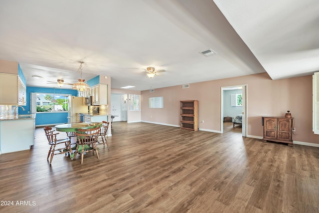 dining room with visible vents, wood finished floors, and a ceiling fan