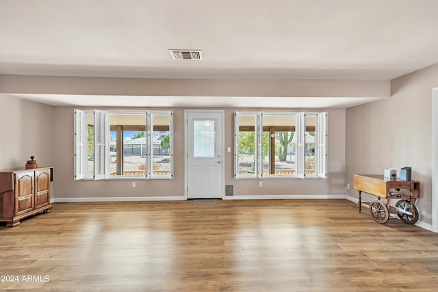 interior space with visible vents, baseboards, and light wood-style floors