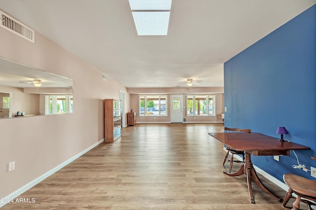 interior space featuring visible vents, a healthy amount of sunlight, a ceiling fan, and wood finished floors