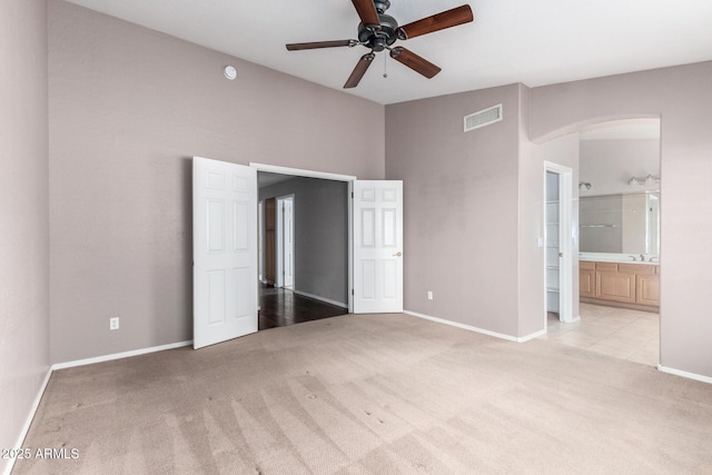 3002 S Marigold Pl, Chandler, AZ 85248 - unfurnished bedroom with visible vents, carpet floors, arched walkways, connected bathroom, and baseboards