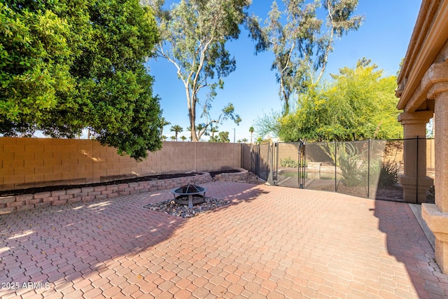 3002 S Marigold Pl, Chandler, AZ 85248 - view of patio with a fire pit, a gate, and a fenced backyard
