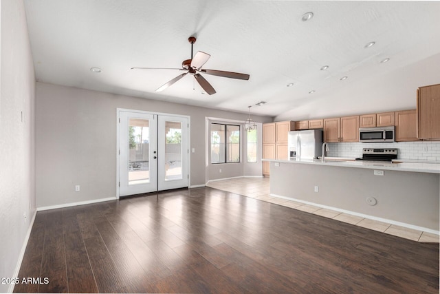 3002 S Marigold Pl, Chandler, AZ 85248 - kitchen with a ceiling fan, stainless steel appliances, a sink, wood finished floors, and light countertops