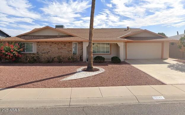 ranch-style house featuring a garage and driveway