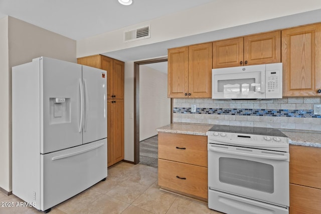 kitchen with white appliances, backsplash, visible vents, and light tile patterned floors
