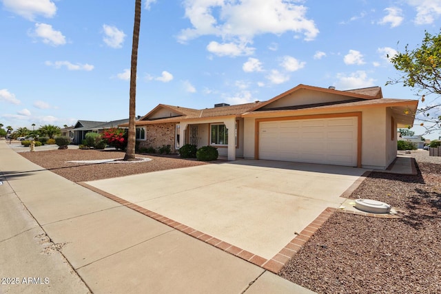 ranch-style home featuring an attached garage, stucco siding, and concrete driveway